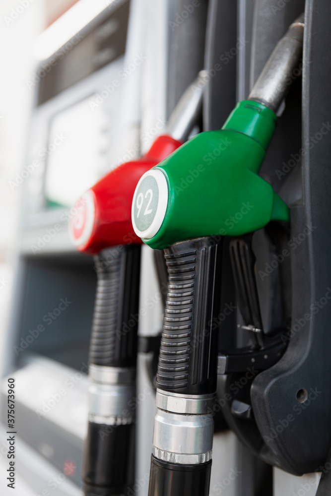 Pistols with gasoline at the gas station. Close-up. Vertical. Pistols with gasoline at the gas station. Close-up. Vertical.