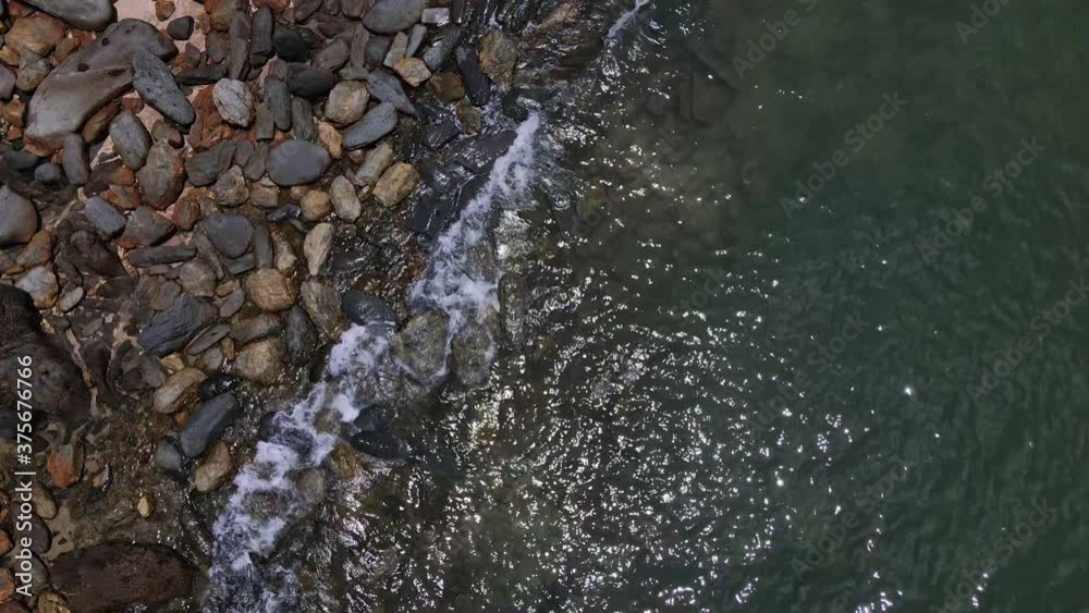 Drone vertical dolly shot of granite rocks, beach and ocean in Thailand
