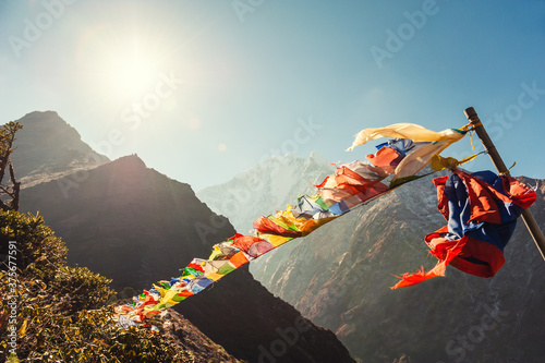 Buddhist prayer flags in Himalaya mountains at sunrise. View of Thamserku mount in Himalayas, Khumbu valley, Everest region, Nepal. © smallredgirl