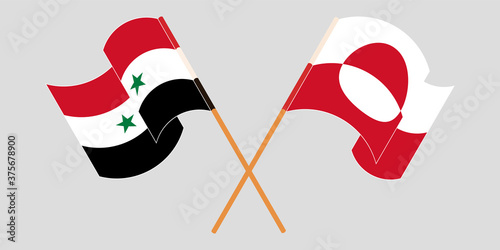 Crossed and waving flags of Greenland and Syria