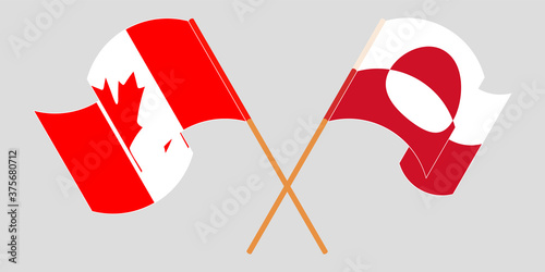 Crossed and waving flags of Greenland and Canada