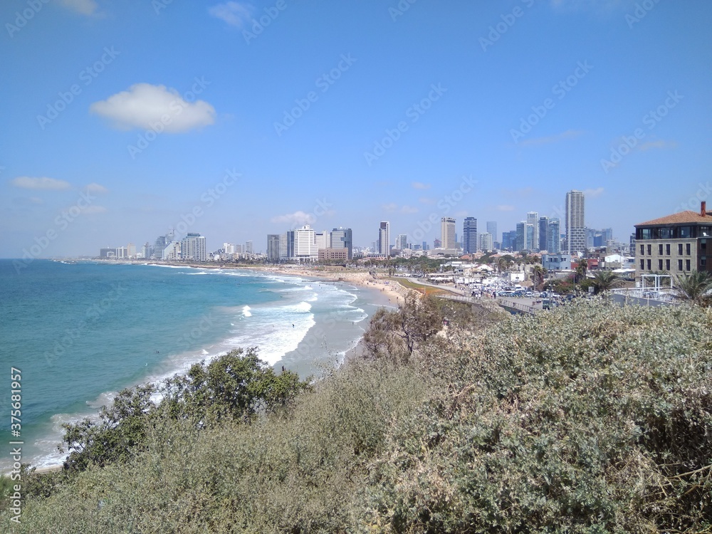Nice view of the Mediterranean Sea and Tel Aviv in summer in Israel. Scenic views of the beaches and modern architecture of Tel Aviv. The photo can be used as a banner for advertising.