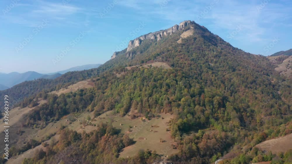 Drone flight over an autumn mountain with peaks, meadows and colorful forests, Balkan mountains, Bulgaria Drone flight over an autumn mountain with peaks, meadows and colorful forests, Balkan mountains, Bulgaria