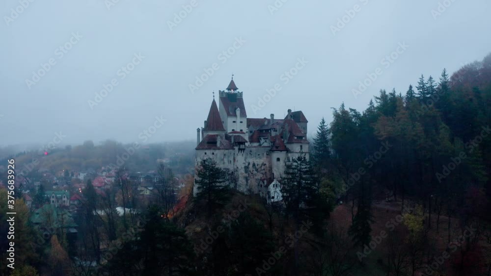 Aerial view of the Bran Castle in Romania under the fog Aerial view of the Bran Castle in Romania under the fog