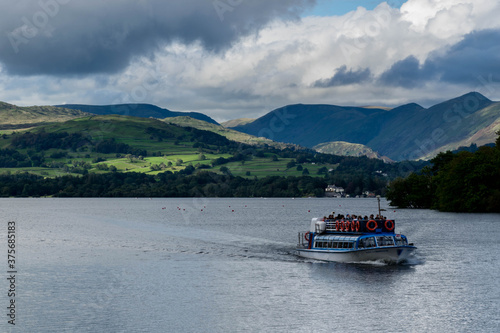 Ferry boat swimming on windermere lake in Lake District
