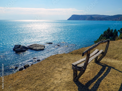 Lonely bench on a high bank above the sea