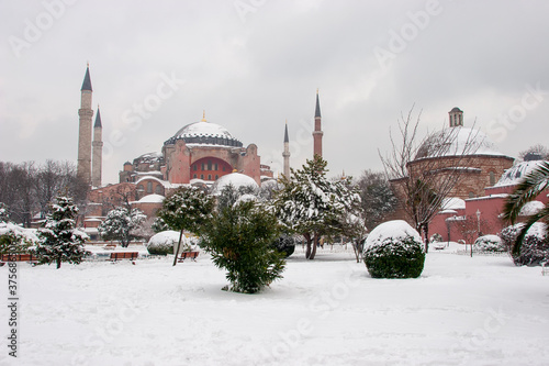 Hagia Sophia mosque and  Hurrem Sultan Bathhouse  at snowy winter in Sultanahmet square, Istanbul City, Turkey photo