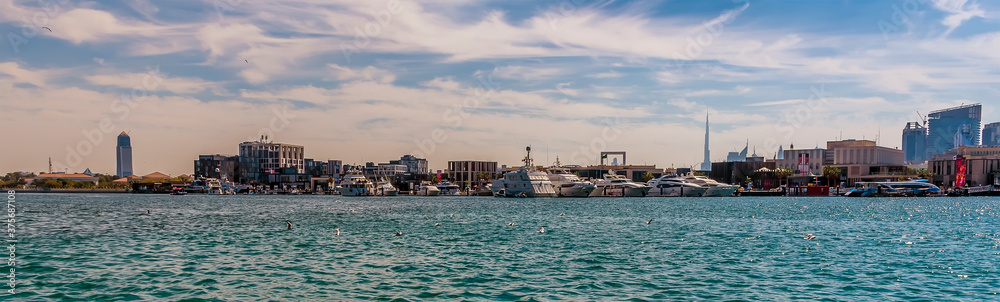 A panorama view across the Dubai Creek towards the silhouette of downtown Dubai in the UAE in springtime