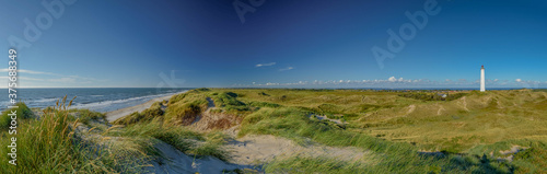 Panoramic view of Lyngvig lighthouse on wide dune of Holmsland Klit with beach view on the west coast of Jutland, by Hvide Sande, Denmark
