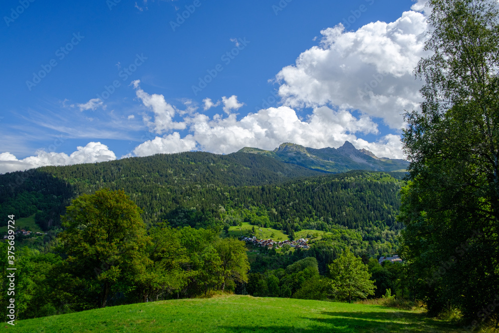 Green landscape with sky and clouds in the Alps