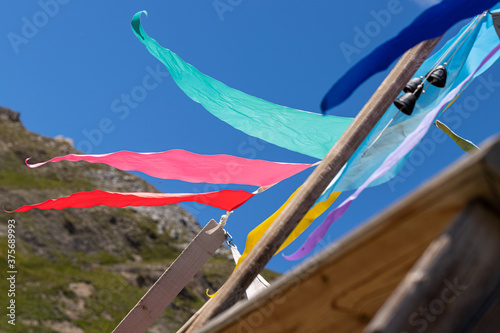 Prayer flag with blue sky - Mountain refuge in the Alps