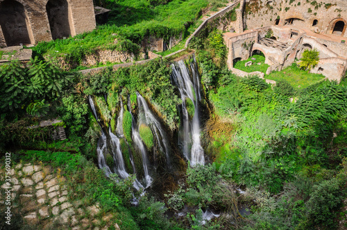 View from the Ponte Gregoriano bridge over the waterfall and the ruins of Villa of Manlio Vopisco. Tivoli, Italy photo