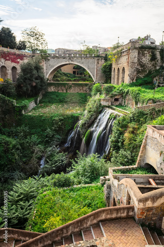 View of the waterfall, the ruins of Villa of Manlio Vopisco and the bridge Ponte Gregoriano. Tivoli, Italy photo