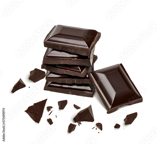 Broken or cracked dark chocolates bar with tablet chocolates isolated on white background. photo