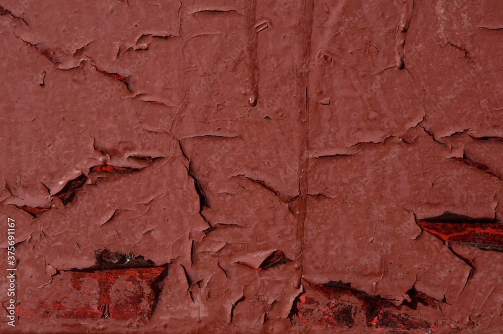 Texture of old red rusty painted metal wall with smudges closeup Texture of old red rusty painted metal wall with smudges closeup