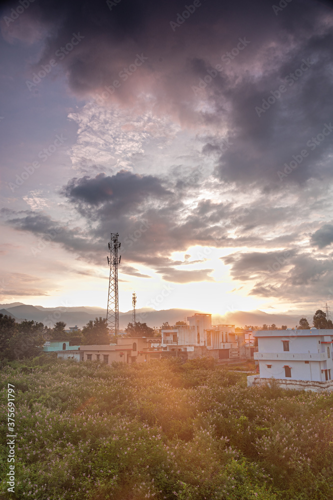 Tower with sunrise and cityscape