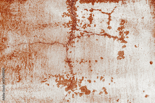 Texture of old red painted building wall with cracks and smudges close up