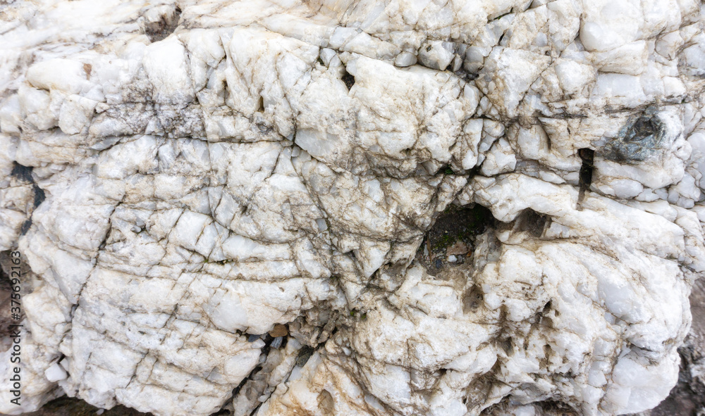 Fototapeta premium White quartz boulder background with space for text. White quartz crystals texture. Natural boulders in landscape design.