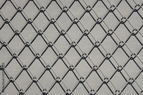 Texture of gray metal lattice on gray background close up