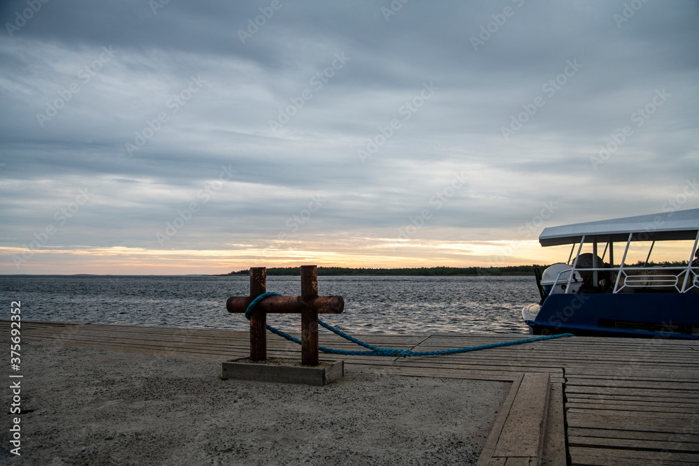 beautiful landscape with old wooden port, stones and sea at sunrise beautiful landscape with old wooden port, stones and sea at sunrise
