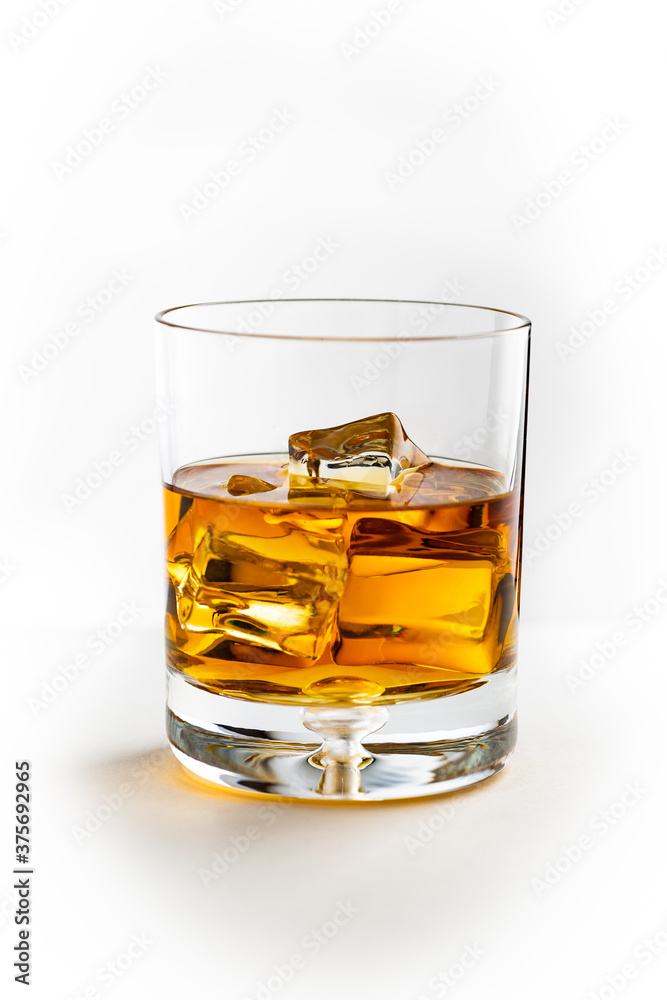 A glass of Kentucky bourbon on rocks isolated on white background