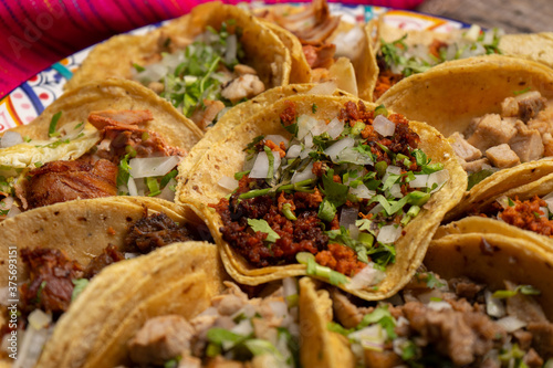 Assortment of mexican tacos on wooden background photo