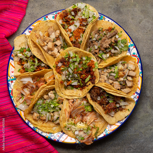 Assortment of mexican tacos on grey background