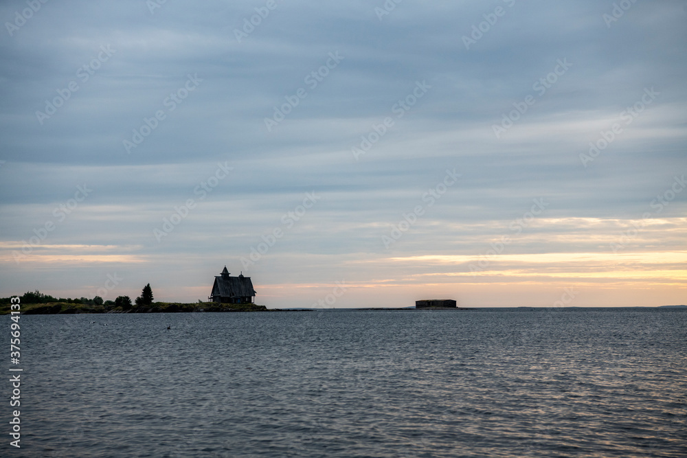 beautiful landscape with old wooden port, stones and sea at sunrise
