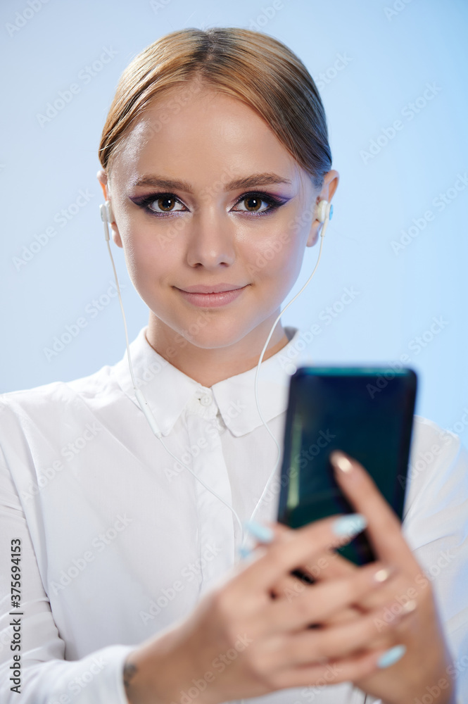 Beautiful girl hold smartphone with selfie camera Beautiful girl hold smartphone with selfie camera