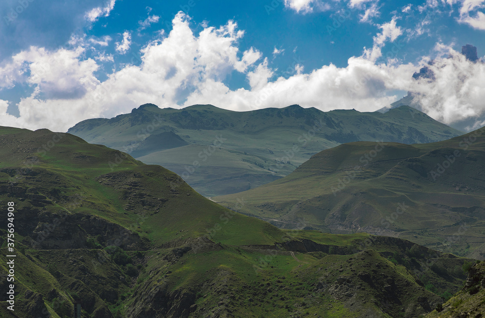 Mountain landscape with blue sky. Panoramic view of green hills. Mountain landscape with blue sky. Panoramic view of green hills.