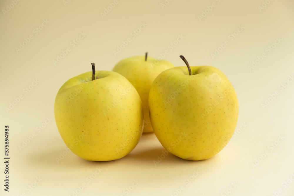 yellow golden delicious apples on yellow background yellow golden delicious apples on yellow background