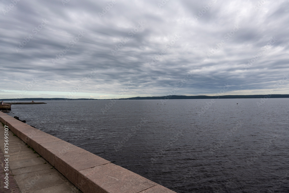 Fototapeta premium houses on the embankment near a large lake on a gray background