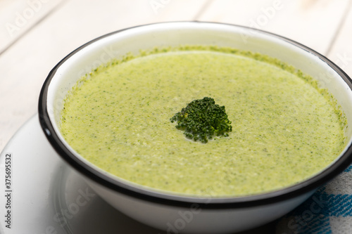 Cream of broccoli soup on white background