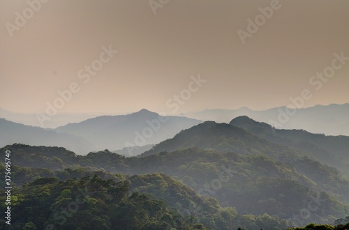 Mountain tops in misty sunset