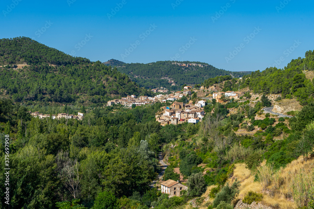View of a beautiful rural town located on the side of a mountain surrounded by a lot of very green vegetation