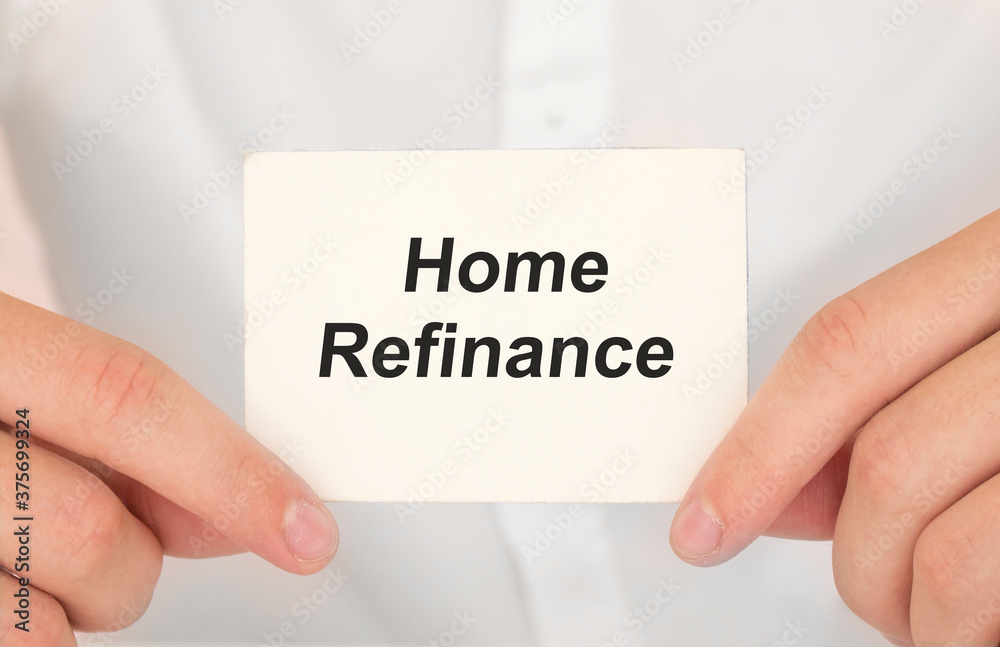 Man's hands take a card with words Home refinance, finance and business concept. Man's hands take a card with words Home refinance, finance and business concept.