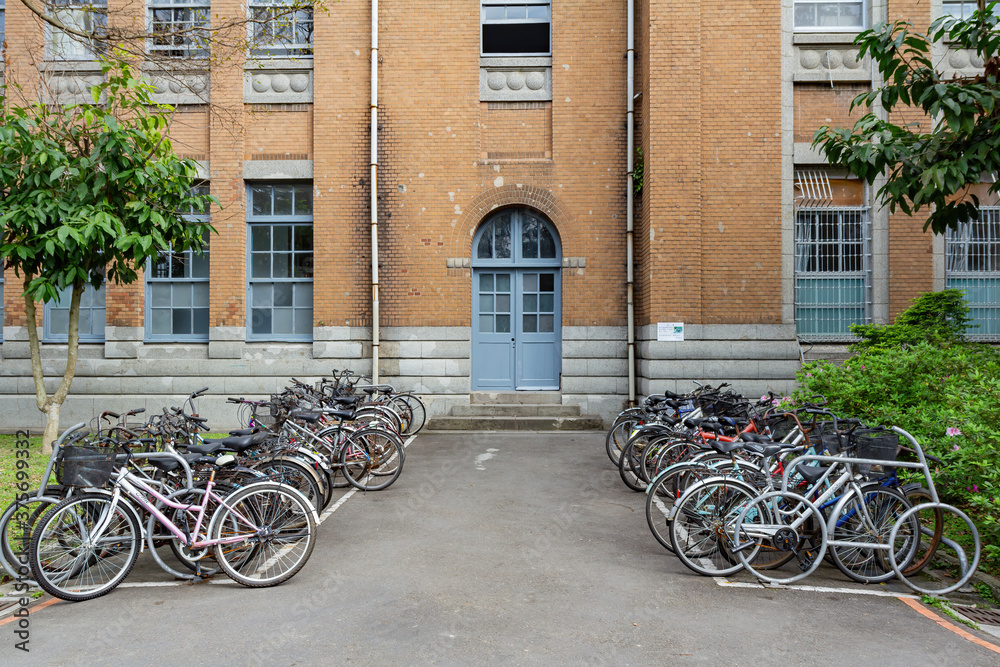 Many bicycle parked in front of a building in NTU