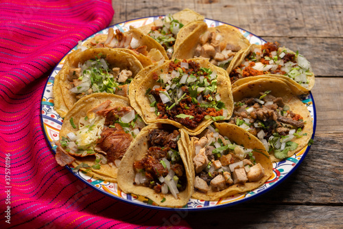 Assortment of mexican tacos on wooden background photo