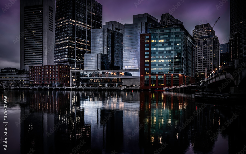 Fototapeta premium Moody Nightscape of Central Boston Financial District and reflections on the Boston Harbor