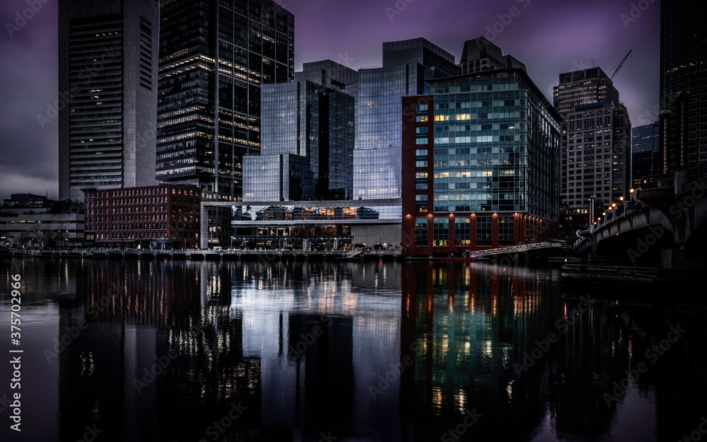 Moody Nightscape of Central Boston Financial District and reflections on the Boston Harbor