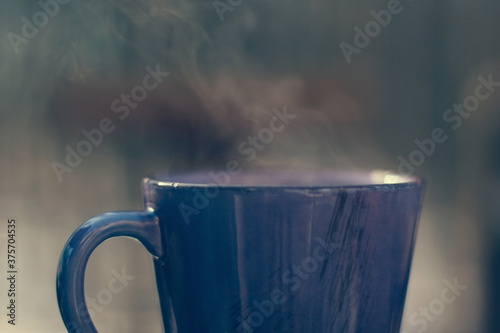 Closeup of steaming coffee in purple mug