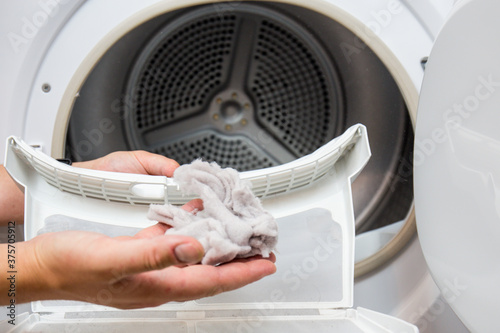 Dryer filter, dirty and needs to be cleaned, clothes dust has gathered in one place