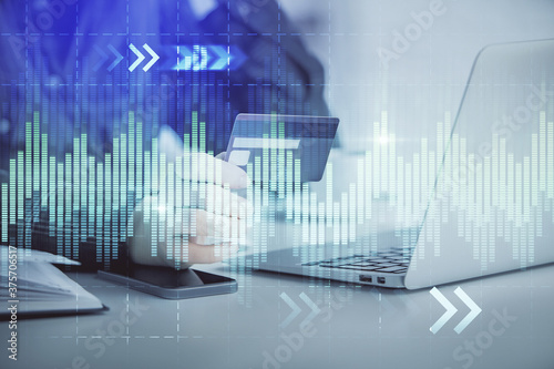 Multi exposure of woman on-line shopping holding a credit card and financial graph drawing. Stock market E-commerce concept.