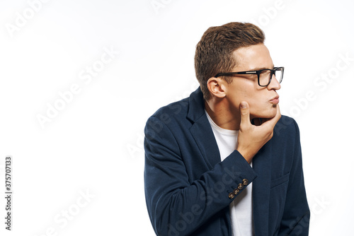 Business man in a jacket with glasses emotions official manager light background studio