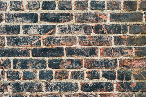 old, scratched, handmade brick wall