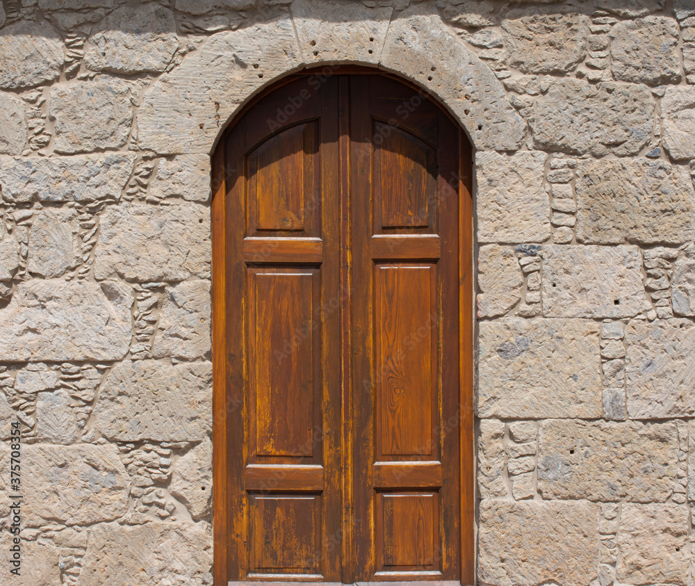 Old Medieval door in a stone wall Old Medieval door in a stone wall