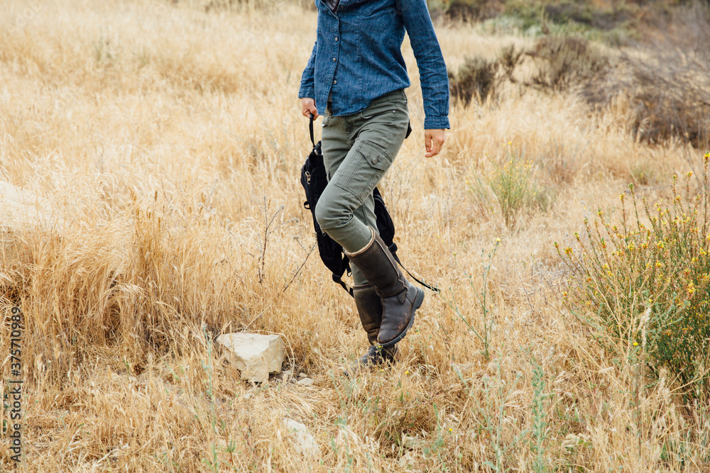 Young woman walking on nature trail Young woman walking on nature trail