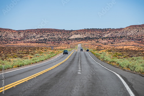 Asphalt road in USA. Empty asphalt highway and blue sky. Long Desert Highway California.