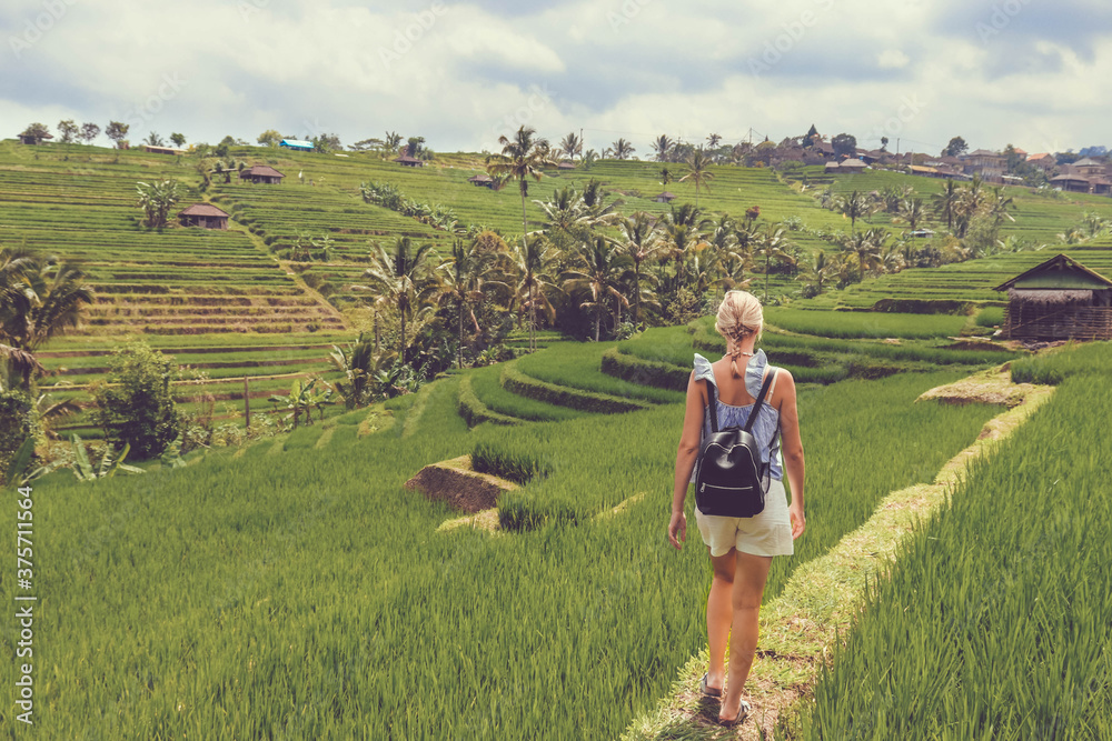 Woman walking in rice fields in Bali