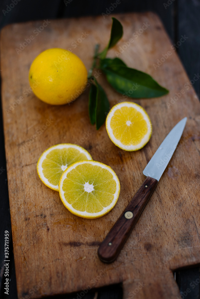Food: sliced lemons on wooden board Food: sliced lemons on wooden board
